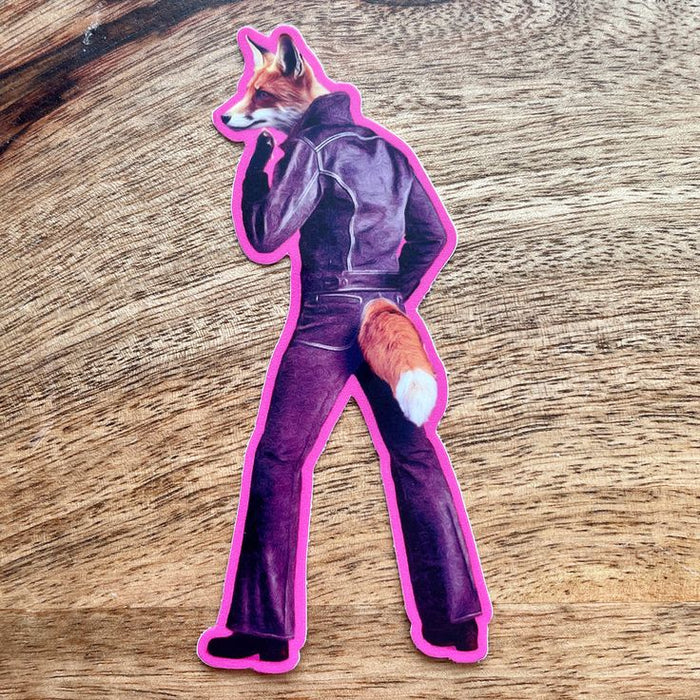 Sticker of a fox in a suit on a wooden surface