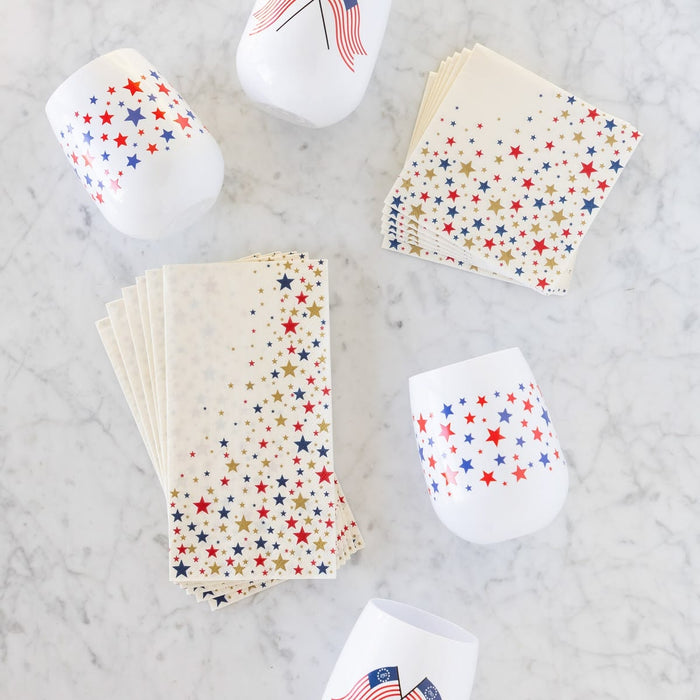 Star-patterned paper cups and napkins on a marble surface