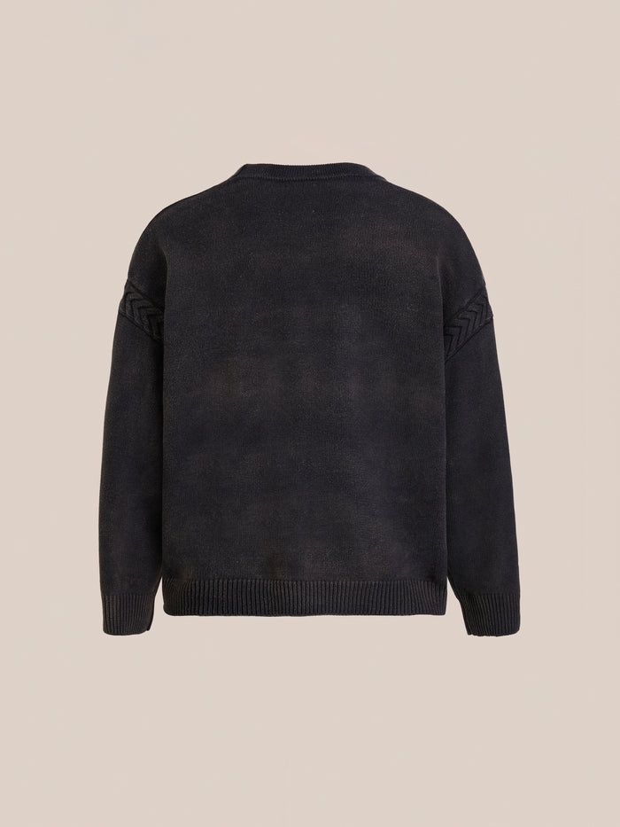 The FOUND Argyle Knit Cardigan is shown from the back on a beige background, featuring ribbed cuffs, hem, and subtle knit detailing on the upper sleeves for a classic, versatile look.