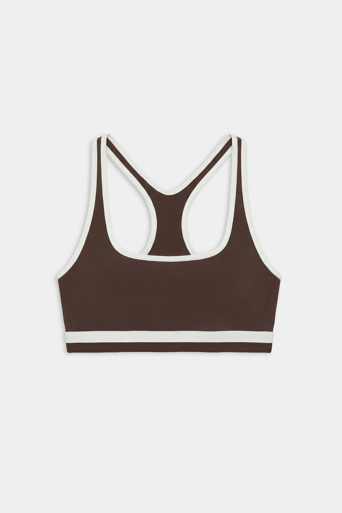 The SPLITS59 Bianca Rigor Bra in Dark Chocolate/White features a racerback design with white trim, made from stretchy nylon spandex, displayed on a white background.