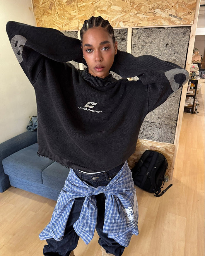 COZY CURVED KNITWEAR BLACK - black distressed knit sweater, front view on female model - Cold Culture