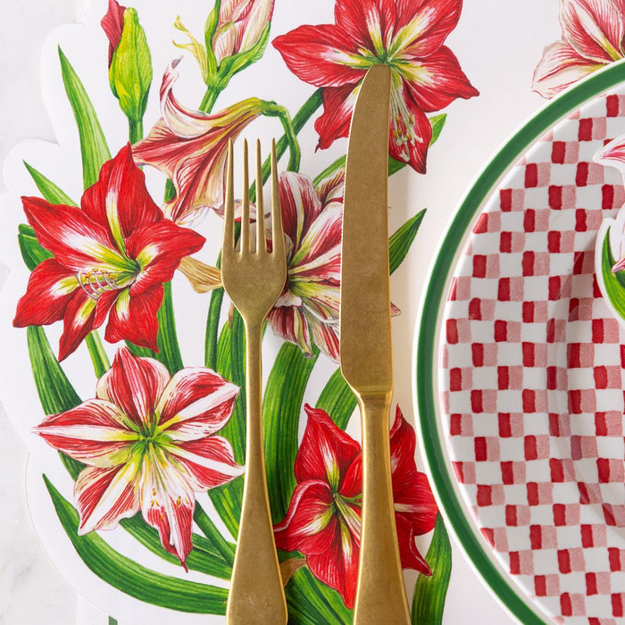 Gold fork and knife on a floral and checkered tablecloth