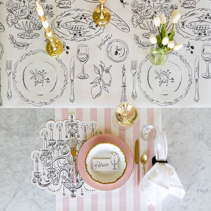 Decorative table setting with place mats, plates, and cutlery on a marble surface.