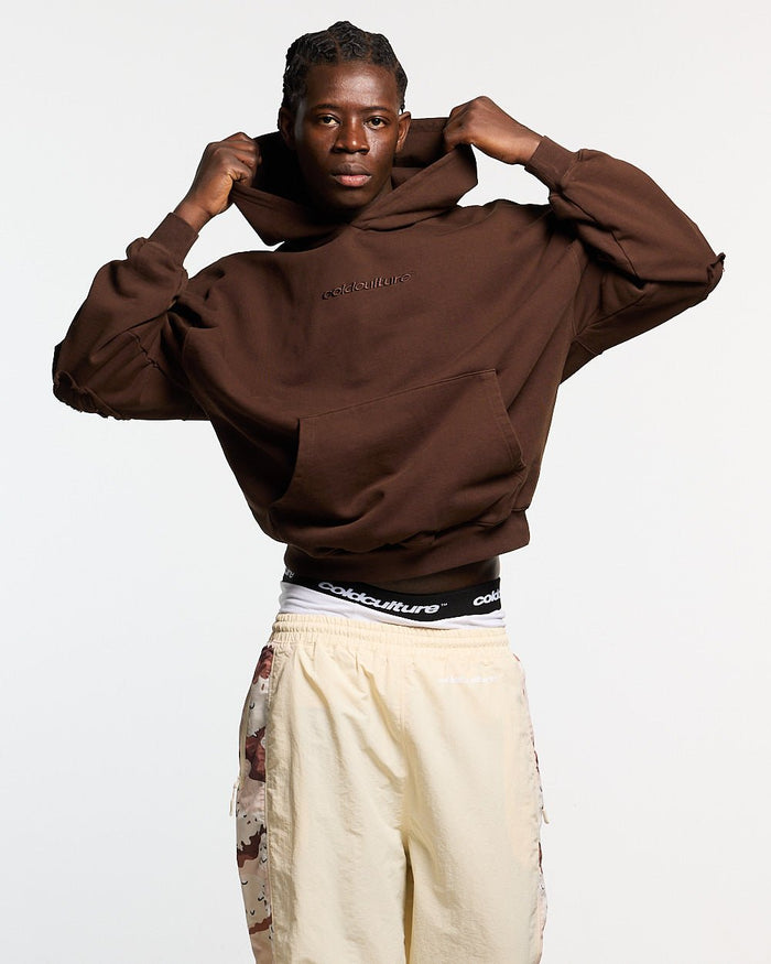 DISTRESS CURVED HOODIE BROWN - brown distressed hoodie, front view on male model - Cold Culture #man
