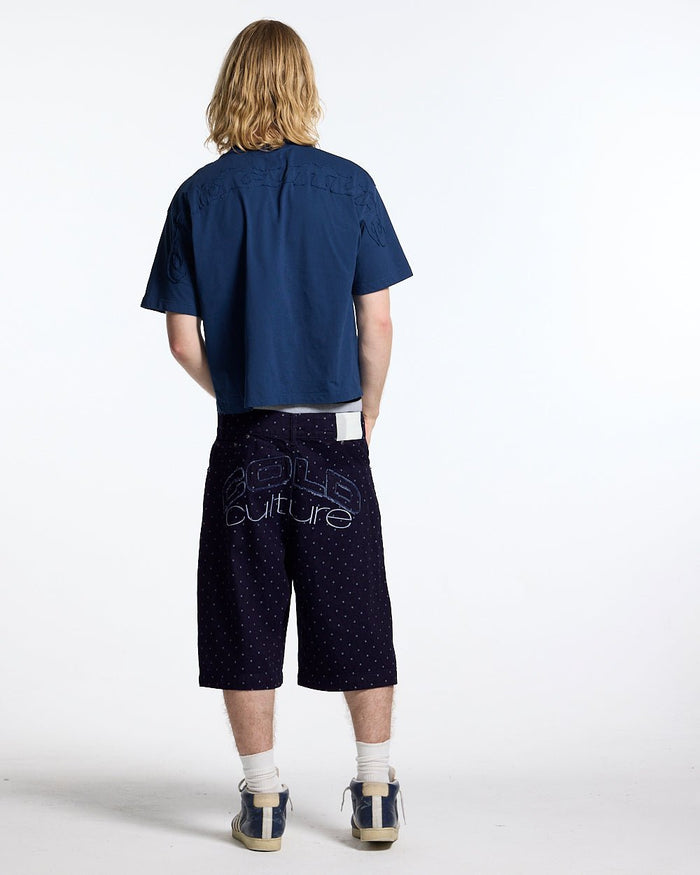 DISTRESS CURVED TEE NAVY - navy blue boxy tee, back view on male model - Cold Culture