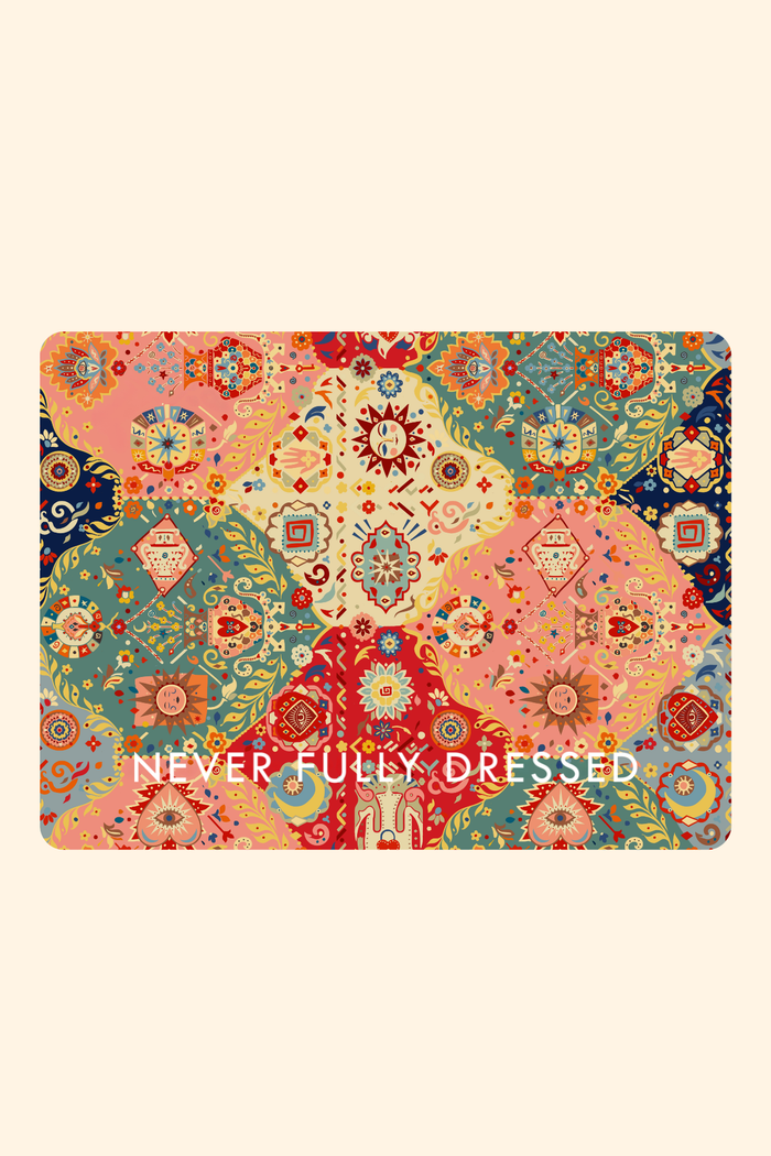 Never Fully Dressed e-Voucher featuring a vibrant multi-coloured patchwork print with celestial sun and moon motifs.