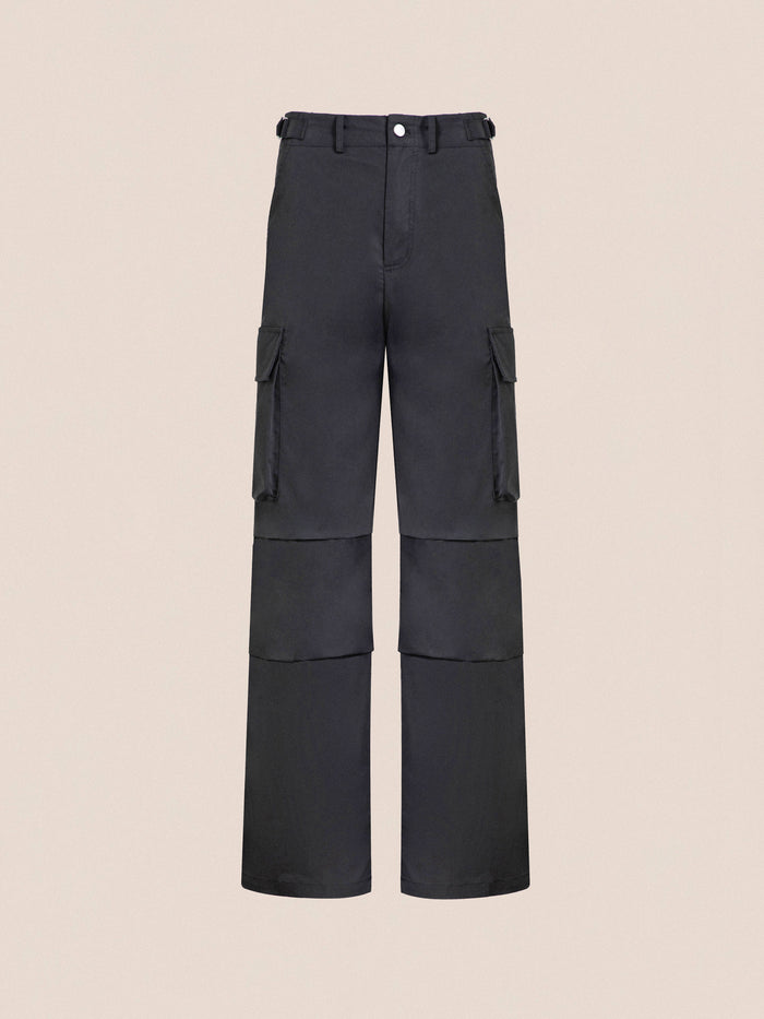 Black Found Elbas Cargo Pants with multiple pockets and a front button, displayed against a neutral beige background.
