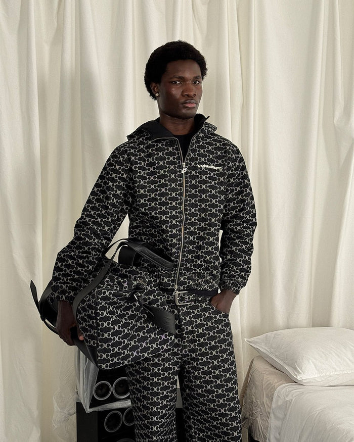 FEVER JACKET BLACK - black monogram hooded jacket, front view on male model - Cold Culture
