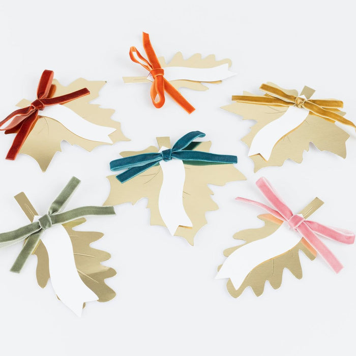Decorative paper snowflakes with colorful ribbons on a white background