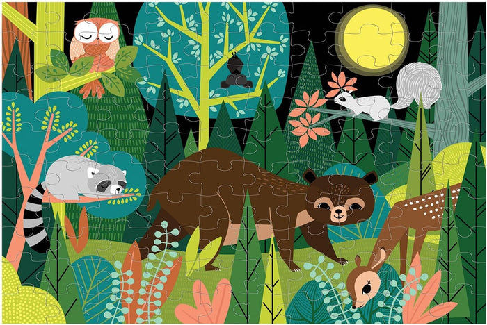 A completed children's jigsaw puzzle featuring a whimsical forest scene with animals including an owl, raccoon, bear, deer, squirrel, and a fox under a full moon.