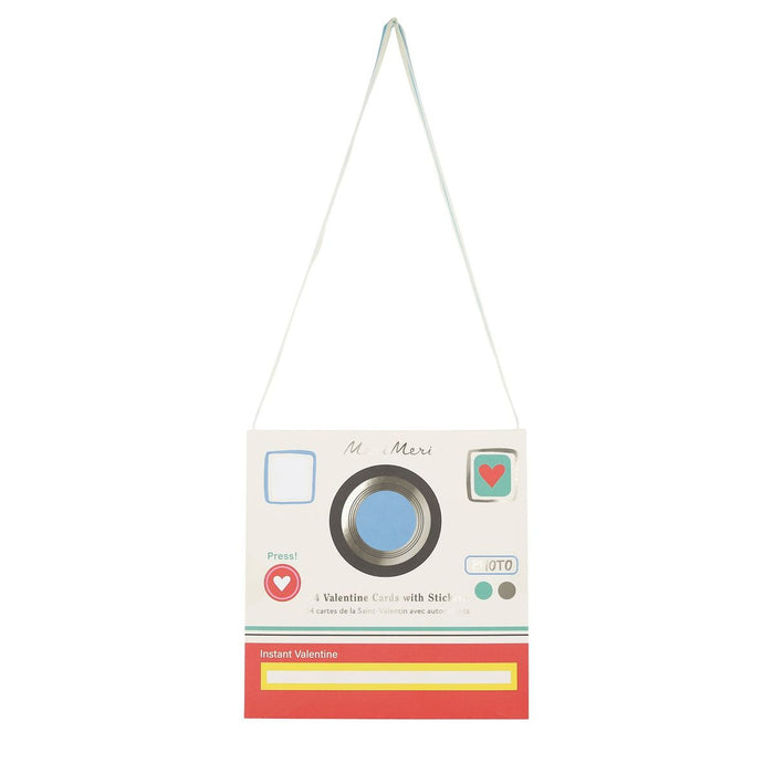 Vintage-style camera-shaped card with a string on a white background