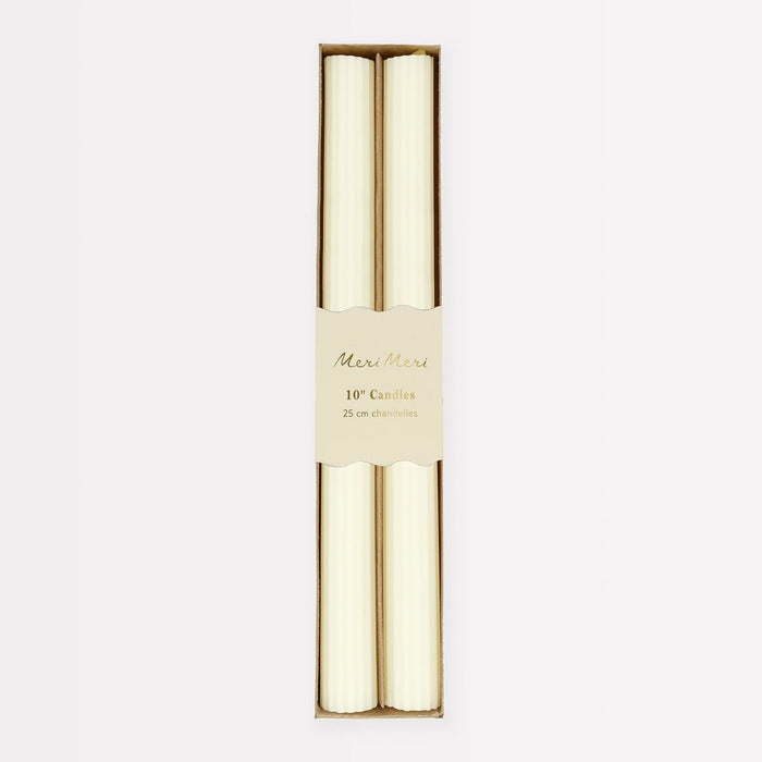 Two candles in a decorative box with 'Merci Merci' branding on a white background
