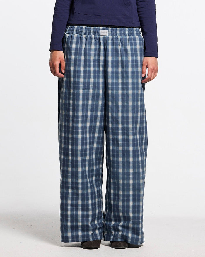 LIAR PANTS BLUE - blue plaid women's sweatpants, front view on female model - Cold Culture