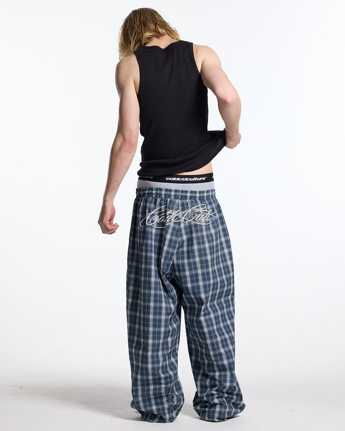 LIAR PANTS BLUE - blue plaid women's sweatpants, back view on male model - Cold Culture