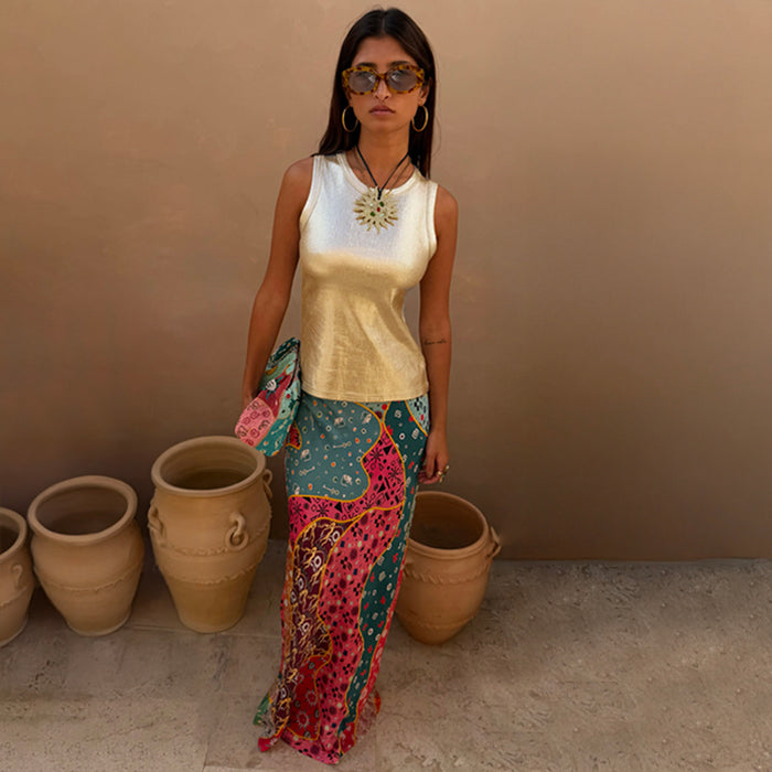 Pastel Morocco Dorris Skirt with multi-coloured abstract prints and NFD motifs, styled with a metallic gold vest.