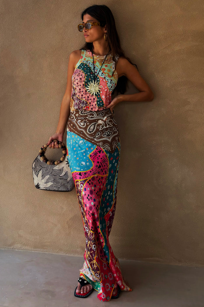 Pastel Morocco Dorris Skirt in a colourful sun and snake print, styled as a co-ord against a neutral wall.