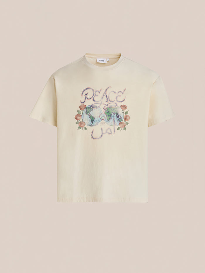 The FOUND Peace Globe Tee is a white vintage cotton shirt with a floral graphic and a unisex relaxed fit for all-day comfort.