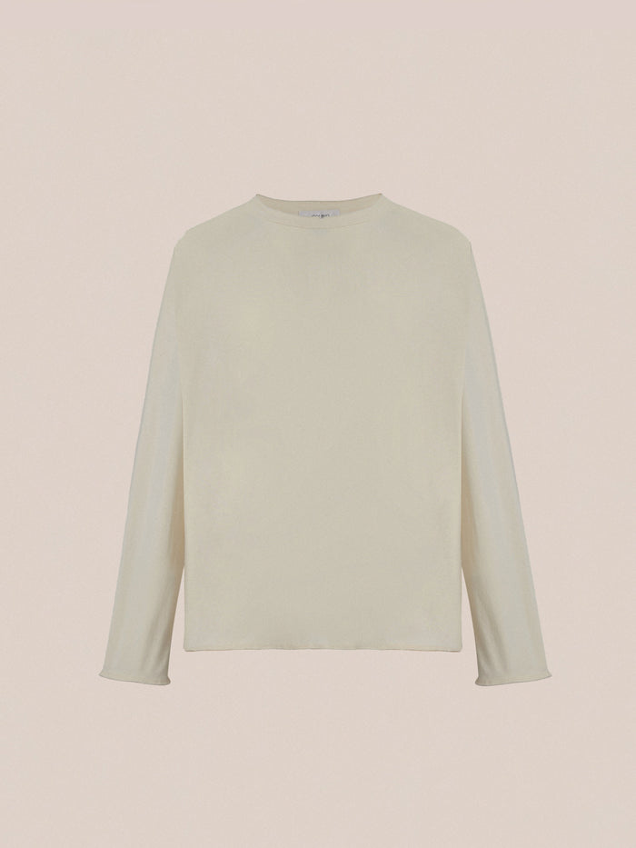 FOUND Reversed LS Tee: light beige unisex long sleeve shirt with a classic crew neckline and subtle distressed detail, shown against a plain beige background.