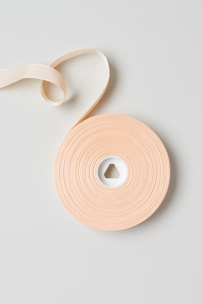 Pink satin Bloch Ribbon Seven Eights Inch flatlay roll of ribbon