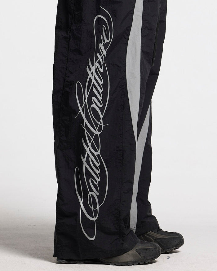 SCRIPT TECH PANTS BLACK - black script print sweatpants, detail close-up - Cold Culture