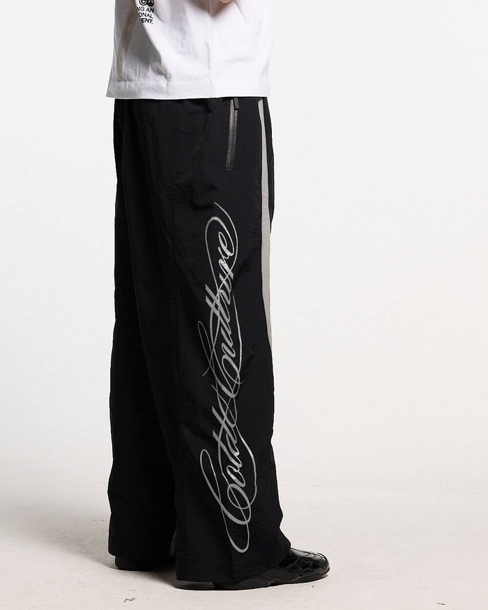 SCRIPT TECH PANTS BLACK - black script print sweatpants, side view - Cold Culture #man