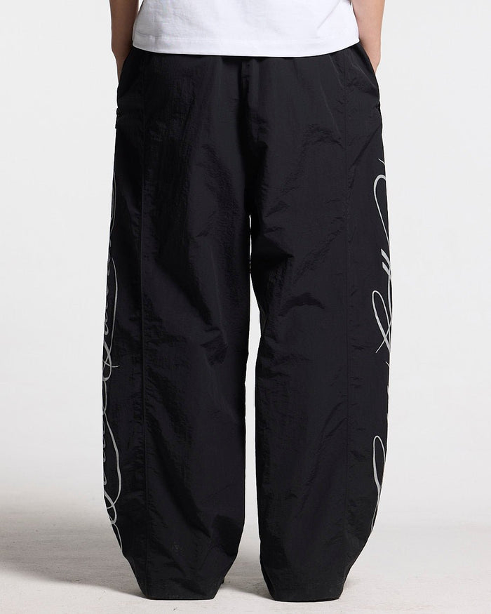 SCRIPT TECH PANTS BLACK - black script print sweatpants, back view - Cold Culture