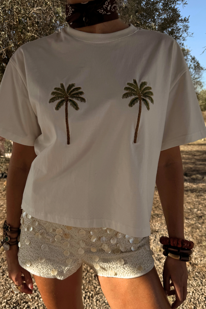 Cream Shells Hot Pants with shell and glass beading, styled with a palm tree tee for a vacation look.