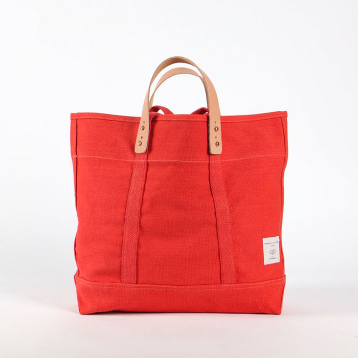Red tote bag with brown handles on a white background