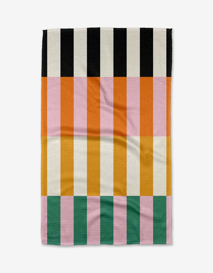 Colorful striped towel with black, pink, orange, and green stripes on a white background