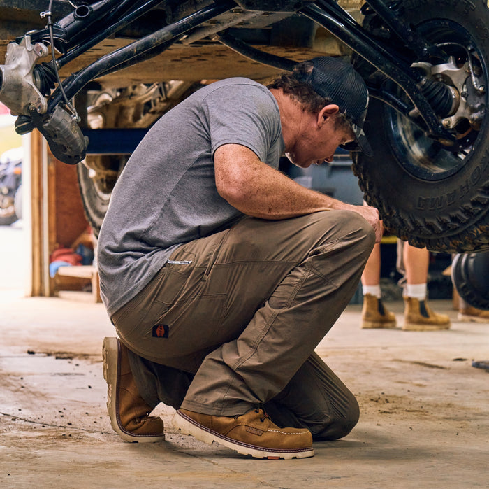 Man on jobsite wearing BRUNT 6 inch waterproof 90 degree composite toe marin work boot in brown