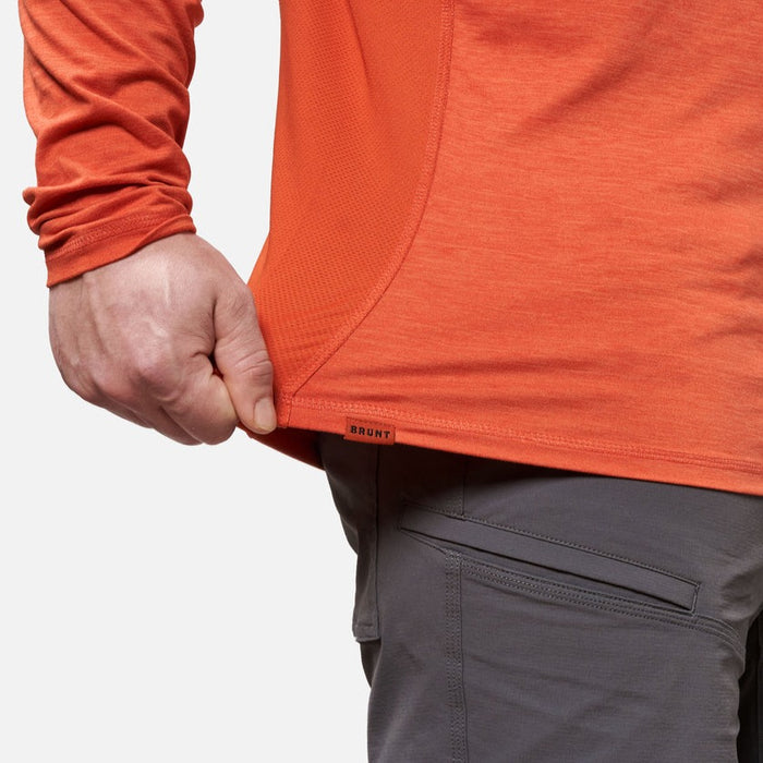 View 2 stretching hemline of the BRUNT lightweight mckenna long sleeve sun tee with UPF protection in BRUNT orange