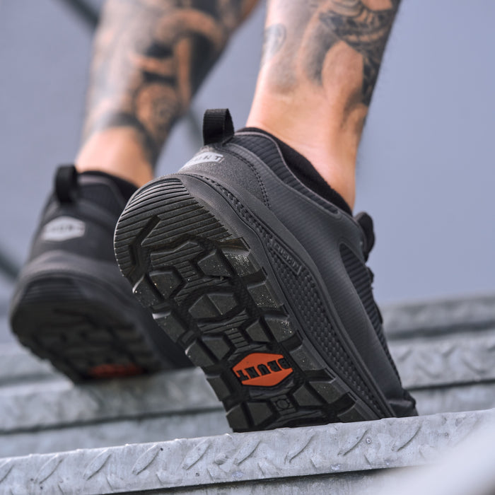Man walking up stairs in BRUNT 4 inch lightweight comp toe work sneaker in black * 0