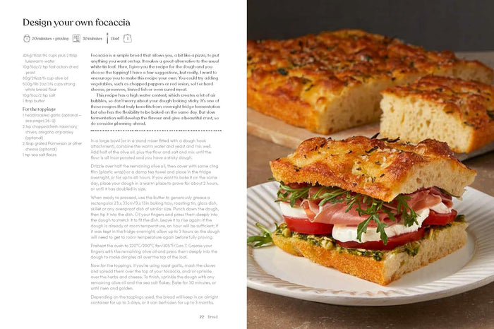 Focaccia bread with a sandwich on a plate next to text on a computer screen.