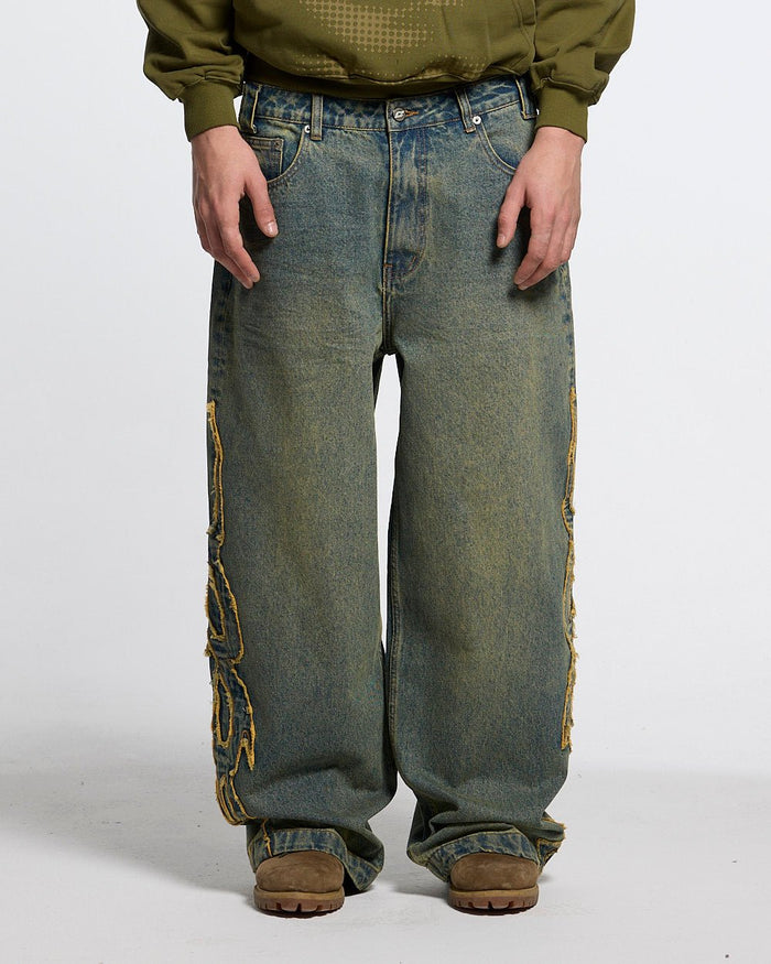 TRIBAL DISTRESSED V2 PANTS GREEN WASHED DENIM - distressed green denim pants, front view on male model - Cold Culture #man