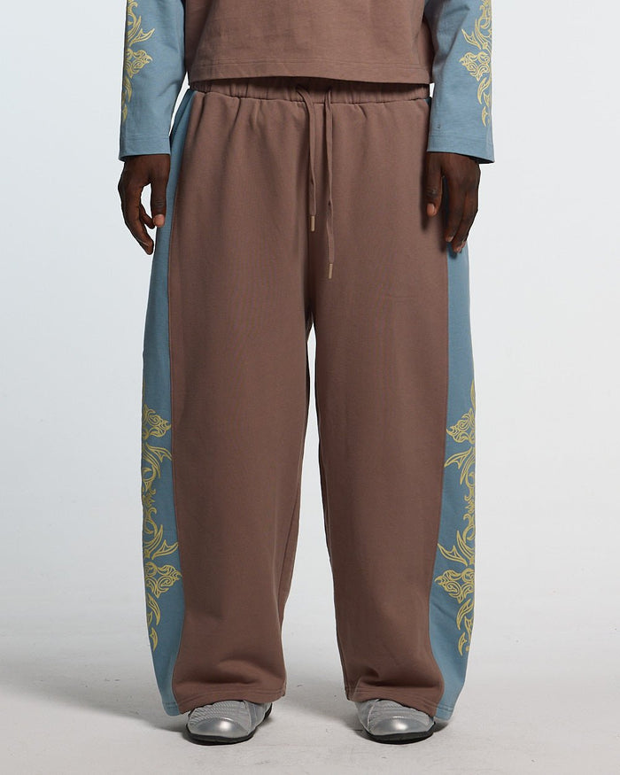 TRIBAL SWEATPANTS BROWN & BLUE - brown and blue tribal sweatpants, front view on male model - Cold Culture #man