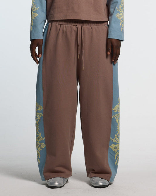 TRIBAL SWEATPANTS BROWN & BLUE - brown and blue tribal sweatpants, front view on male model - Cold Culture #man