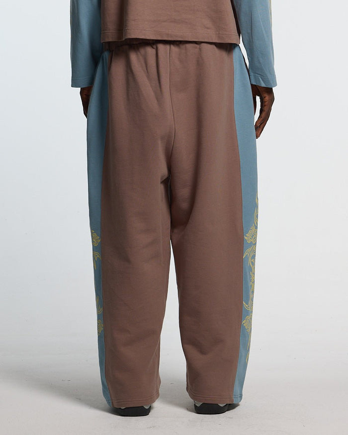 TRIBAL SWEATPANTS BROWN & BLUE - brown and blue tribal sweatpants, back view on male model - Cold Culture #man