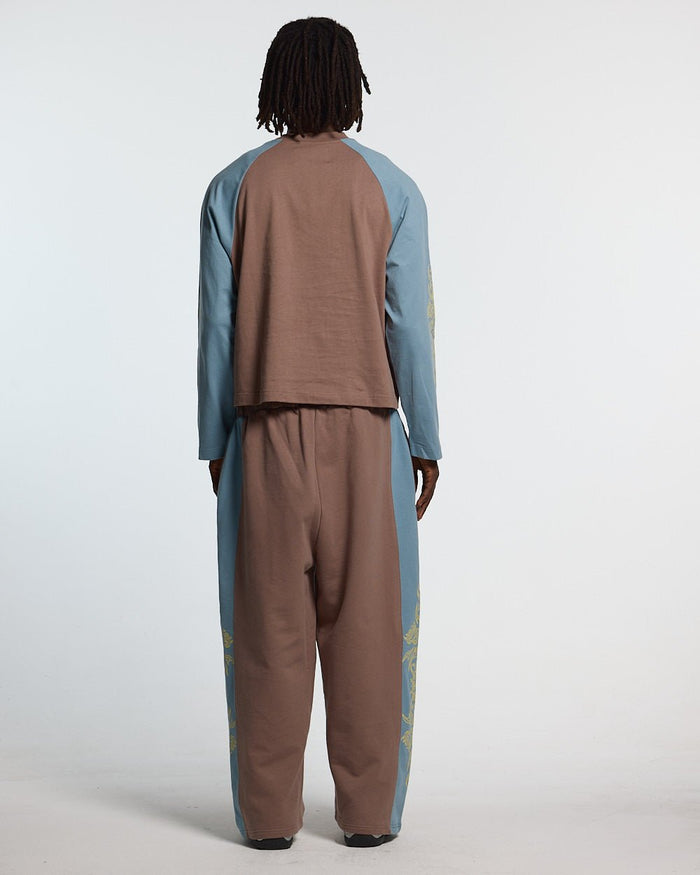 TRIBAL SWEATPANTS BROWN & BLUE - brown and blue tribal sweatpants, back view on male model - Cold Culture #man