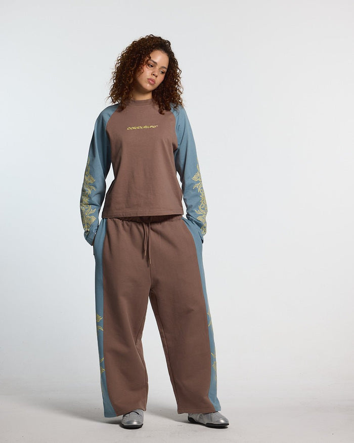 TRIBAL SWEATPANTS BROWN & BLUE - brown and blue tribal sweatpants, front view on female model - Cold Culture #woman