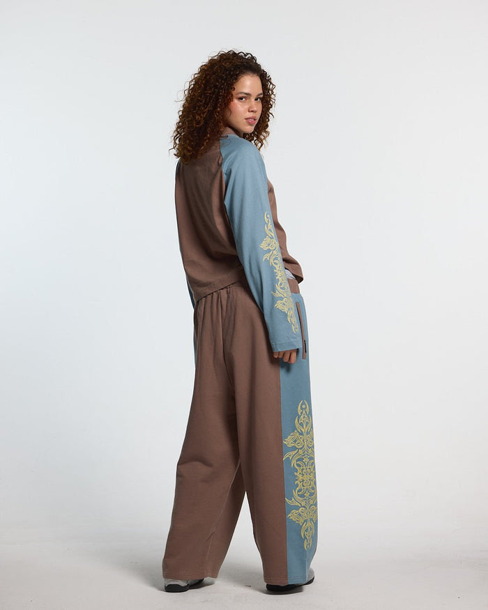 TRIBAL SWEATPANTS BROWN & BLUE - brown and blue tribal sweatpants, back view on female model - Cold Culture #woman