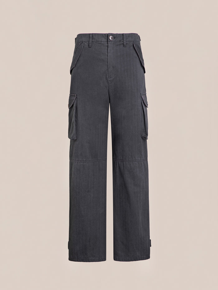 A pair of Utility Herringbone Cargo Pants by FOUND, with six roomy pockets and a unisex relaxed fit, is displayed against a plain beige background.