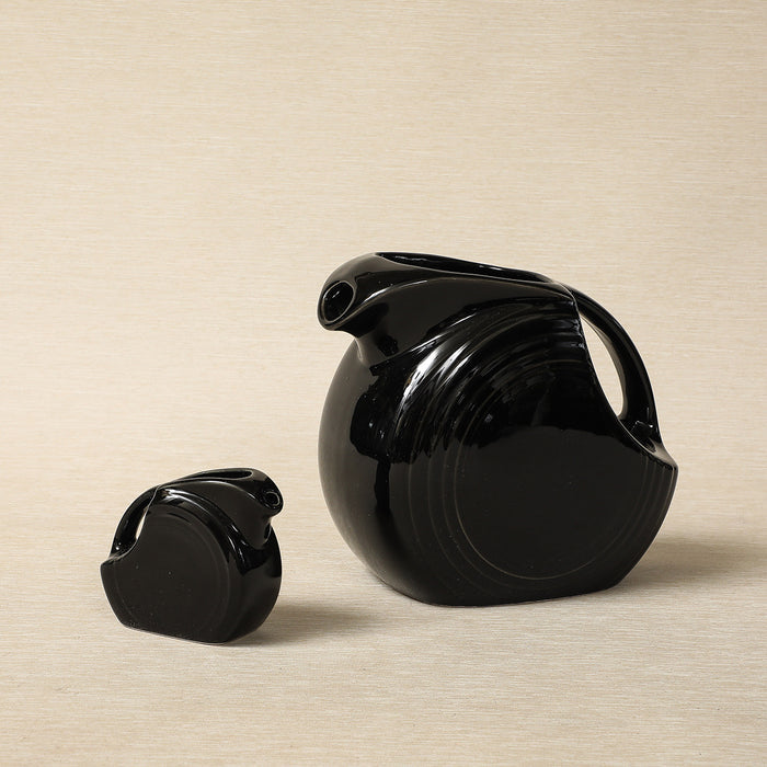 Vintage black-glaze Fiesta-ware disc pitchers