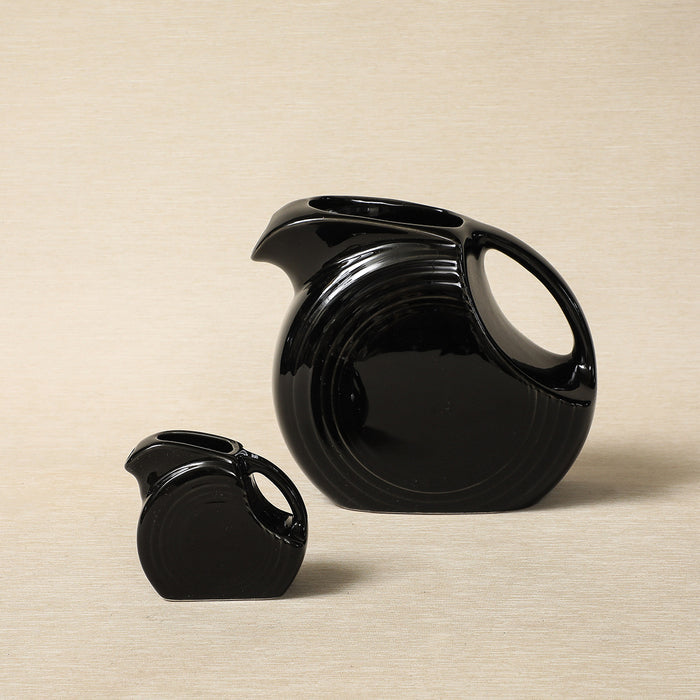 Vintage black-glaze Fiesta-ware disc pitchers