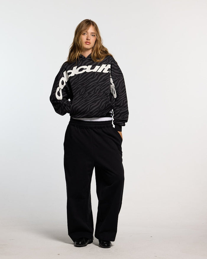 ZEBRA HOODIE BLACK - black zebra print hoodie, front view on female model - Cold Culture #woman